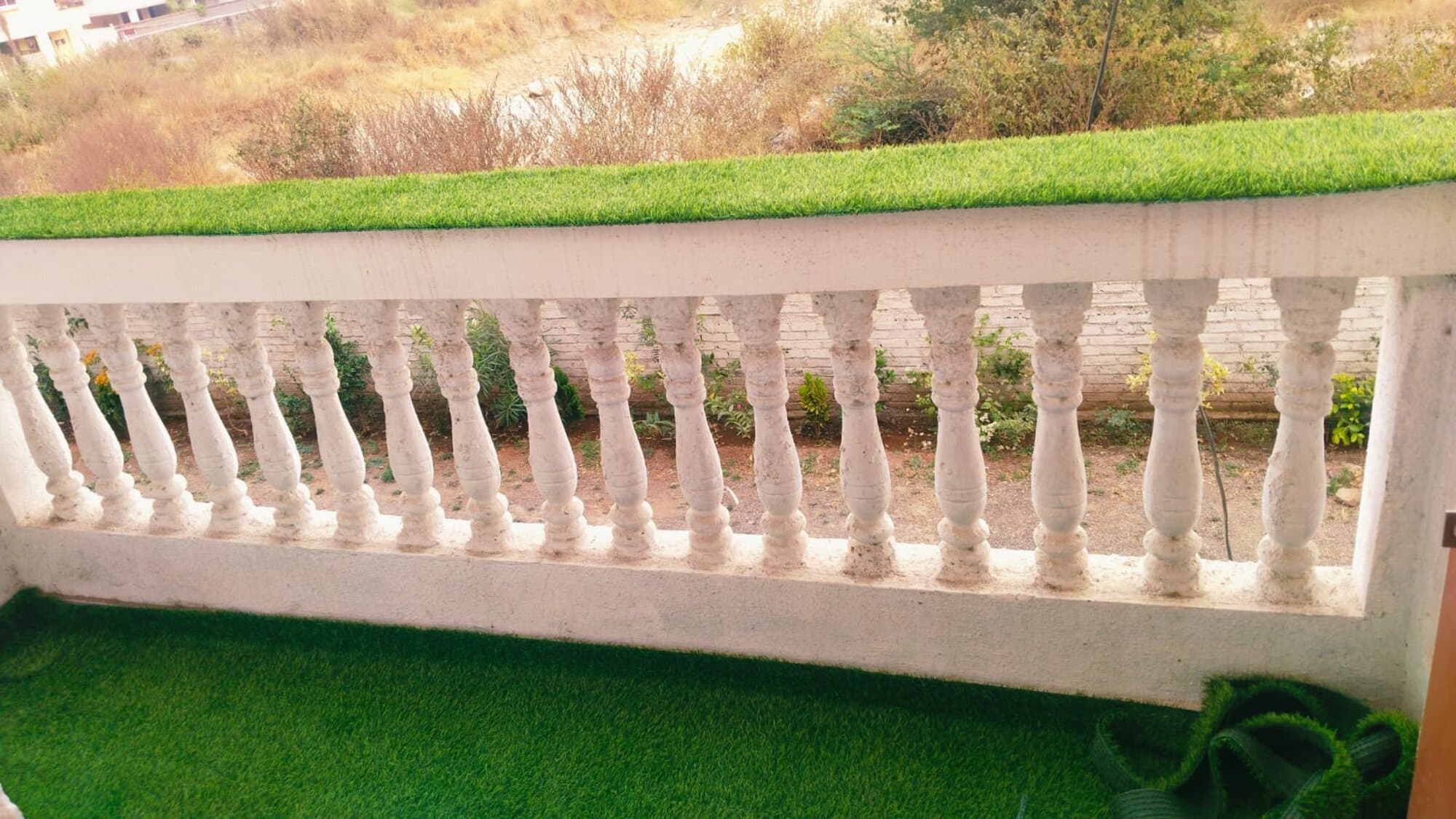 A balcony at Habitat with a turf floor, looking over the garden