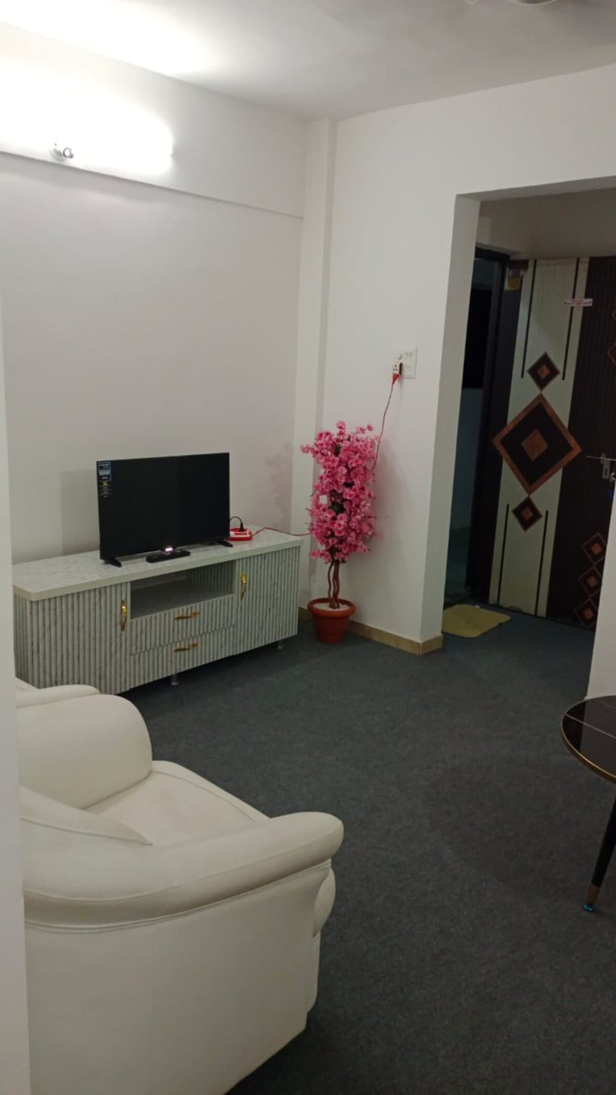 A common lounge at Habitat with seating and a wall-mounted TV